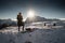 Monte Piana, Italy - January 1, 2019 : silhouette of women hiking in scenic snowy dolomites mountains, with direct sunlight