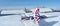 Monte Pora, Bergamo, Italy. A single engined, general aviation light aircraft parked on a snow covered plateau. UK flag colors