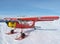 Monte Pora, Bergamo, Italy. A single engined, general aviation red light aircraft parked on a snow covered plateau