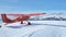 Monte Pora, Bergamo, Italy. A single engined, general aviation red light aircraft parked on a snow covered plateau