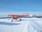 Monte Pora, Bergamo, Italy. A single engined, general aviation red light aircraft on a snow covered plateau is taking off