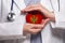 Montenegrin doctor holding heart with flag of Montenegro background. Healthcare, charity, insurance and medicine concept