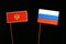 Montenegrin flag with Russian flag isolated on black