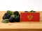 Montenegrin flag on a wooden panel with blackberries isolated on