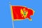 Montenegro flag isolated on blue background
