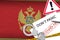 Montenegro flag and police handcuffs with inscription Don`t panic on white paper. Coronavirus or 2019-nCov virus concept
