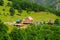 Montenegro mountains. A small village on the slope among the high mountains covered with green forest in the valley of the river