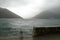 Montenegro port, wavy sea and misty weather. Old wall.
