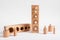 Montessori knobbed wooden cylinders with blocks. Childish puzzle for development of size perception and pincer grip