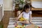 Montessori material. Colored movable alphabet made of wood on a board tray. Child toddler girl