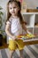 Montessori material. Colored movable alphabet made of wood on a board tray. Child toddler girl