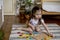 Montessori material. Colored movable alphabet made of wood on a board tray. Child toddler girl