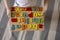 Montessori material. Colored movable alphabet made of wood on a board tray. Child toddler girl