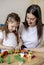 Montessori material. Mom and daughter learn transport through the game. Wooden railroad