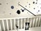 Montessori Munari Mobile carousel hanging and spinning above baby bed. Black and white geometrical shapes that improves babies