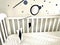 Montessori Munari Mobile carousel hanging and spinning above baby bed. Black and white geometrical shapes that improves babies