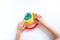 Montessori wood rainbow material. A child plays with a toy with his hands