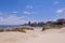 Montevideo beach with sand fence barriers and skyline on a sunny day, Montevideo, Uruguay