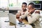 Month-end stresses. a young couple looking stressed while going over their finances on a laptop at home.