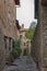 Montichiello - Italy, October 29, 2016: Quiet street in Montichiello, Tuscany with typical shuttered windows and paved streets