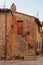 Montichiello - Italy, October 29, 2016: Quiet street in Montichiello, Tuscany with typical shuttered windows and paved streets