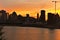 Montreal Downtown skyline at the time between sunset and twilight. Reflections of sun rays on Saint Laurent river.