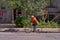 Montreal, Quebec, Canada September 29, 2018: Cyclist of yellow age, in an orange windbreaker, on the cycle path of the city of