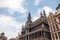 Monument of architecture against blue sky, bell tower, Gothic building bread house, Palace king, Museum keeps statue