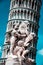 Monument on the background of the famous sloping tower with columns in Pisa, Italy. fascinating exotic amazing places