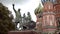 Monument with statues on background of St. Basil`s Cathedral. Action. Famous monument to Minin and Pozharsky on Moscow