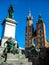 Monument to Adam Mickiewicz and of Towers of the Church of St. Mary on the main Market Square of the Old Town of Krakow, Poland.