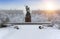 Monument to the Heroic Komsomol- bronze sculpture of a young Red Army man under falling snow in St. Petersburg, Russia. Focus on f