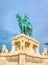 Monument to King Matthias against the background of the towers of the Fisherman`s Bastion in Budapest