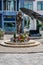 Monument to Mother Teresa on the backdrop of a flower-shaped solar battery in Shkoder, vertical