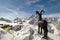 Monument to a mountain goat on the background of a ski lift and the high peaks of the Caucasus Mountains