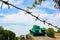 Monument to the old Soviet tank T-34. A military tank stands on a pedestal against the backdrop of a blue sky, barbed wire, green