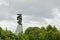 Monument to the sailors and fishermen perished in the sea over tree tops Liepaja parc