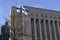 the monument to third president of Finland Pehr Evind Svinhufvud, waving Finnish flag and Finnish parliament building, December 6