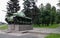 Monument to the winner tank. The machine is mounted on a granite pedestal. Green alley. Tracked armored vehicle. Transport.