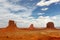 Monument Valley iconic rock formations under cloudy blue sky