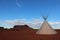 Monument valley landscape with tipi and blue sky