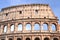 Monumental Colosseum in Rome against blue sky, Italy