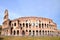 Monumental Colosseum in Rome against blue sky, Italy