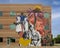 Monumental mural by artist Haylee Ryan Yale on a medical office building at Valoris Health Park in Garland, Texas.