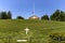 The monumental pantheon at Arlington National Military Cemetery, with a white marble cross and tomb in Washington DC.