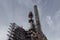 Monumental view looking up of steel industry complex with chimneys and walkways