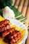 `Moo ping` grilled pork Thailand style Served with sticky rice on banana leaf