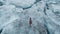 Moody Aerial View Of Girl Walking On Ice River