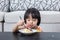 Moody Asian Chinese little girl eating birthday cheese cake