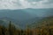 Moody autumn dramatic highland pine forest nature scenery landscape view with gray cloudy sky and sun rays through clouds October